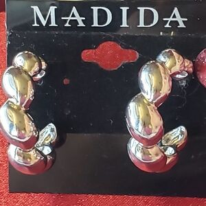 Madida Silver Tone Earrings. Definitely Iconic Twist Bubble Hoop Earrings.